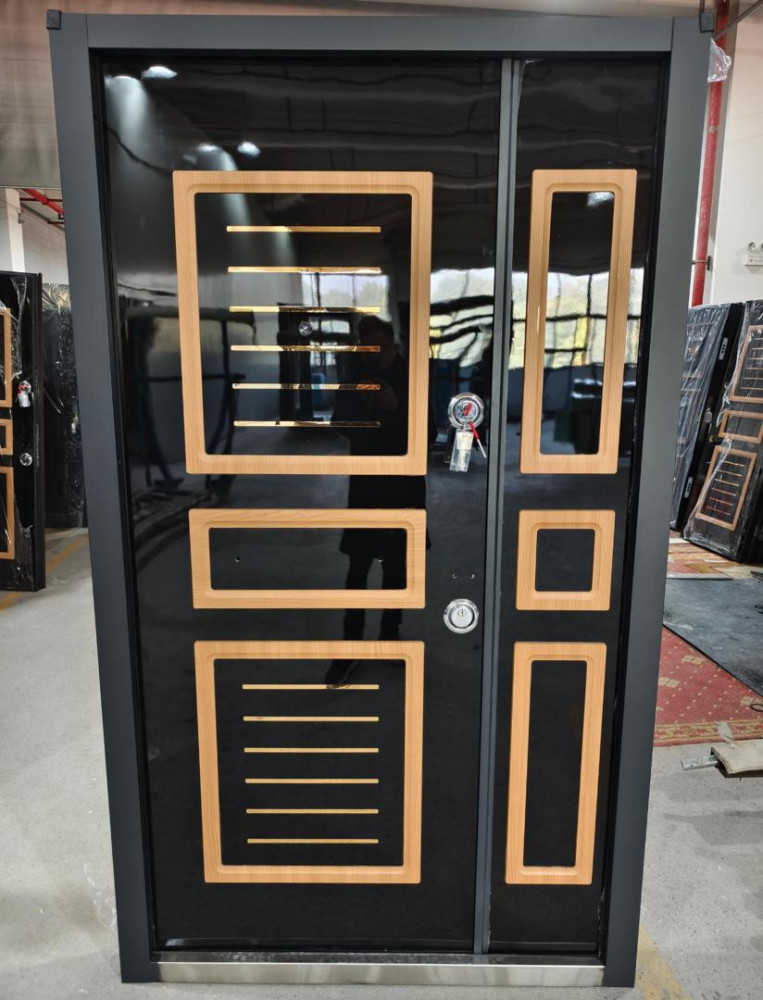 Modern black security Door with wooden trim and gold accents likely of turkish origin