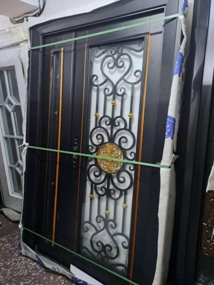 Heavy-duty wrought Iron security Door with a disctive black finish and gold accents
