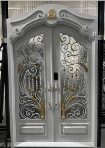 White and gold security door with a decorative wrought iron and glass design