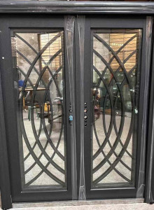 Modern black wrought Iron double entry door with an intricate geometric design
