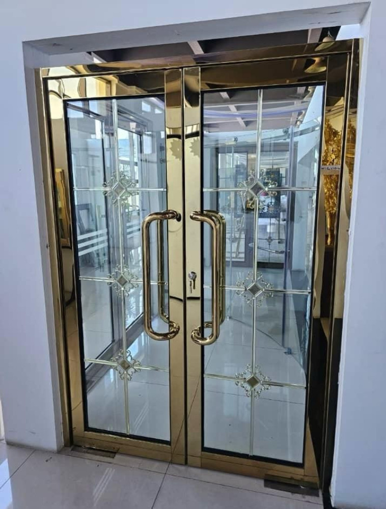 Gold-framed glass entrance door