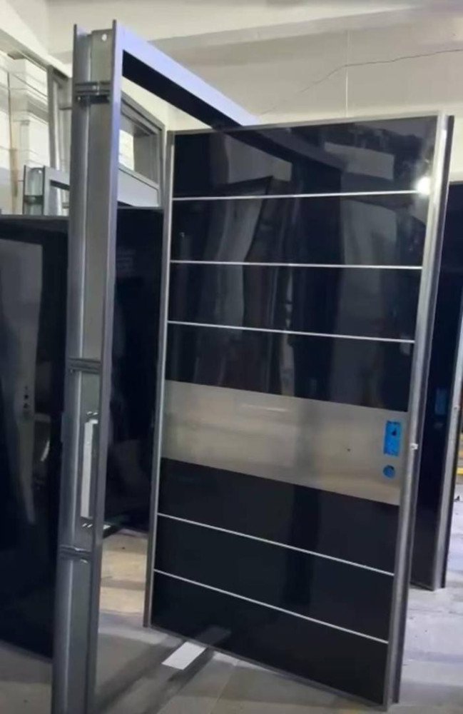 Modern Security Pivot door black glossy panels and horizontal metalic accents