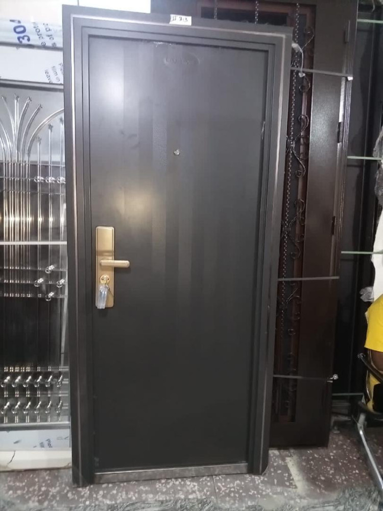 Grey Steel Security Door with a gold-tone handle and lock