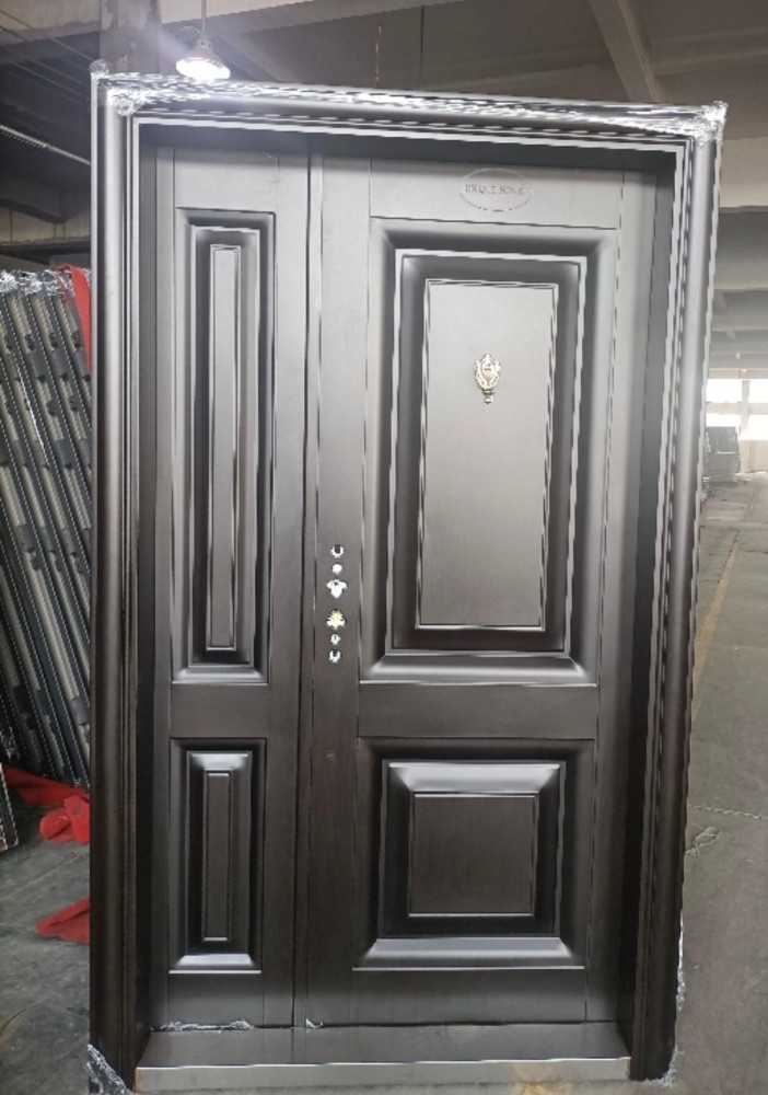 Custom Steel Entrance Door featuring ornamental scrollwork and a modern design