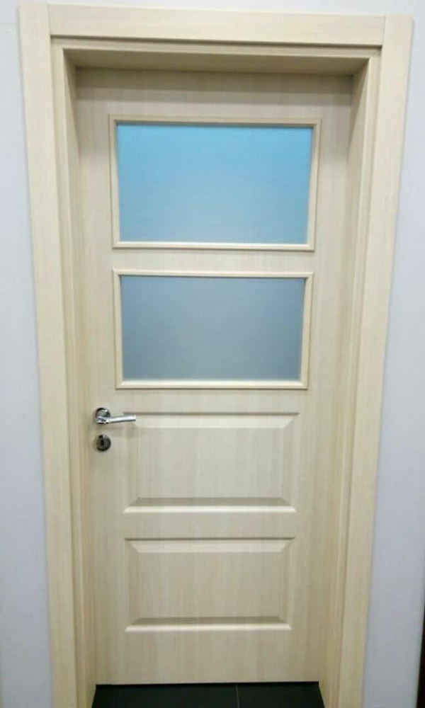 Interior door featuring two rectangular frosted glass panes in the upper half nd recessed panels in the lower half