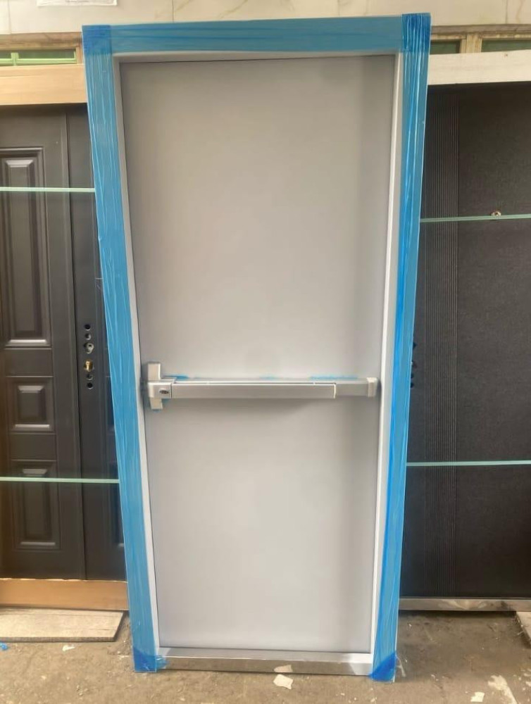 fire-rated steel commerical door quiped with a panic bar for emergency 