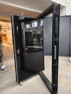Modern pivot security Door with a sleek black glass finish and vertical handle