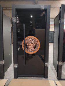 Turkish Luxury Security Door featuring a black finish an a prominent Versace-design medusa emblem handle