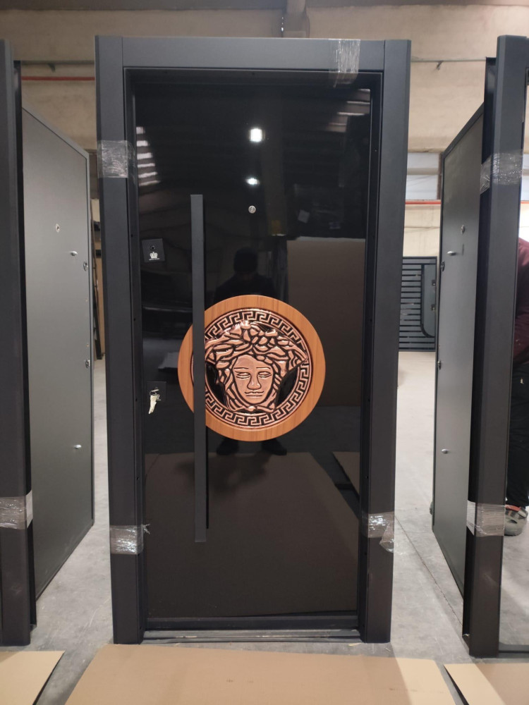 Turkish Luxury Security Door featuring a black finish an a prominent Versace-design medusa emblem handle