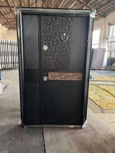 Modern metal security doorfeaturing a decorative textured panel, vertical ribbed sections nd a geometric patttern inlay