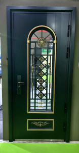 Modern metal security door featuring a decorative glass panel wit gold-accented metal work 