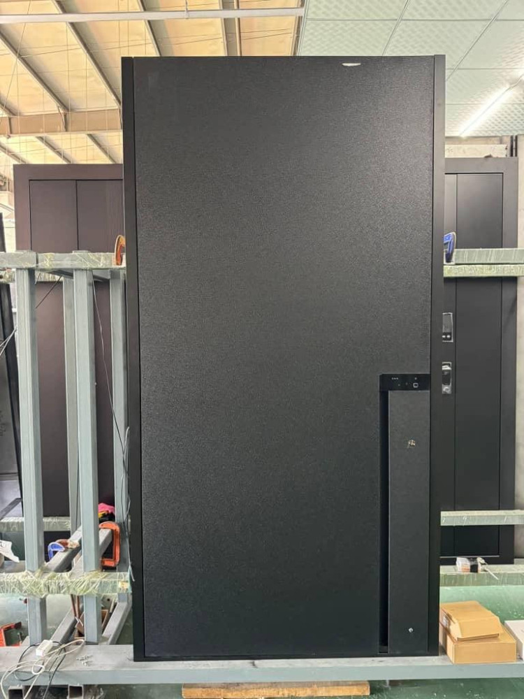 Modern, dark-coloured refrigerator, likely a built-in or integrated model designed to blend seamlessly with cabinetry