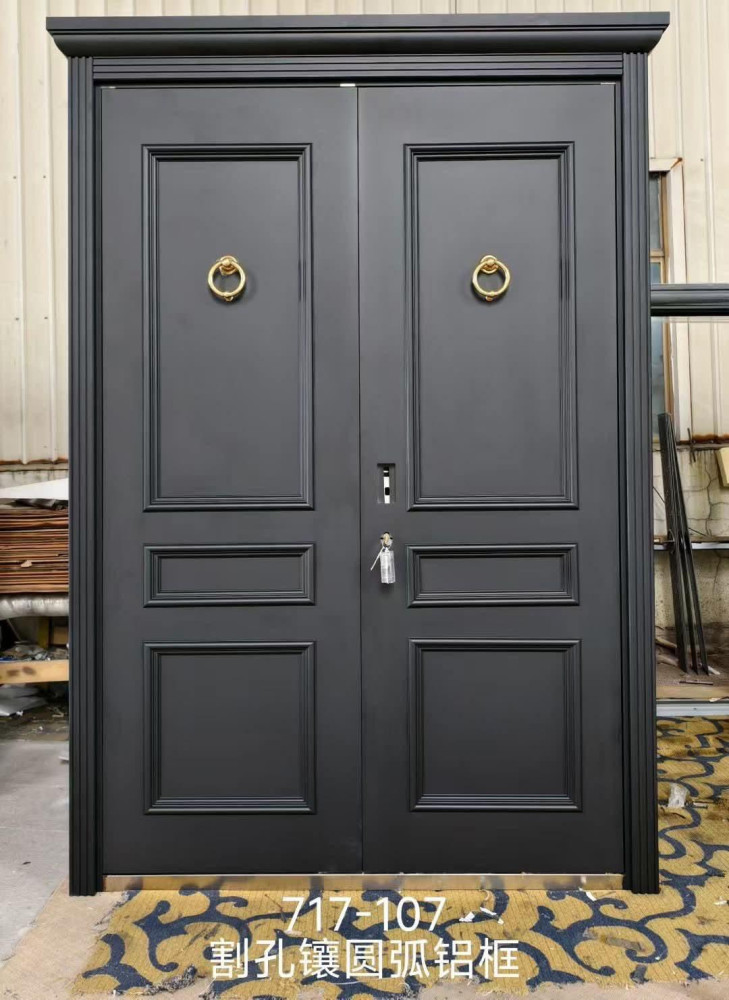 black metal double security door features a matte finish, recessed panels, and ornate gold-coloured circular door knockers