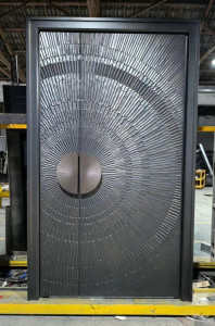 Modern cast aluminum front door featuring a distinctive circular embossed design suitble for entrances