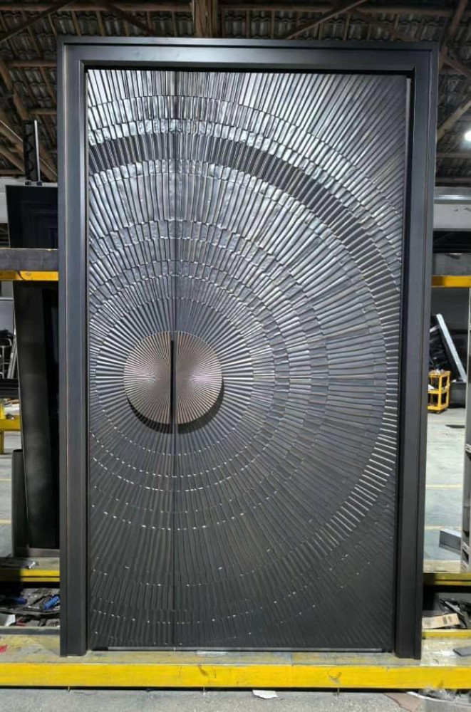 Modern cast aluminum front door featuring a distinctive circular embossed design suitble for entrances