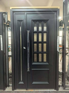 Black steel security door features a french glass design and a large moder handle
