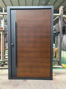 Modern Exterior steel door features a wood-grain finish and a large vertical pull handle, commonly referred to as pivot door