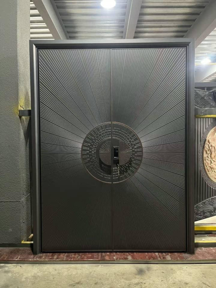 Modern cast aluminum or steel double security entry door featuring a distinctive radial sunburst design
